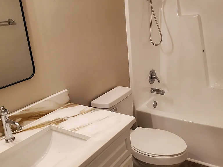 2nd bathroom shared between two bedrooms. New quartz countertops. Refurbished tub and shower.
