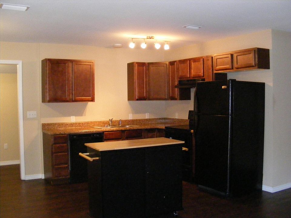 Kitchen has an electric range, dishwasher and refrigerator.