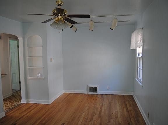 Living room with track lighting & ceiling fan!