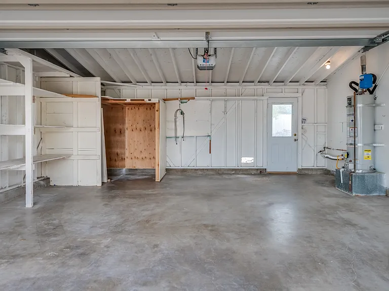 Spacious 2-car garage with plenty of shelving, and backyard access. Washer/dryer hookups located in garage.