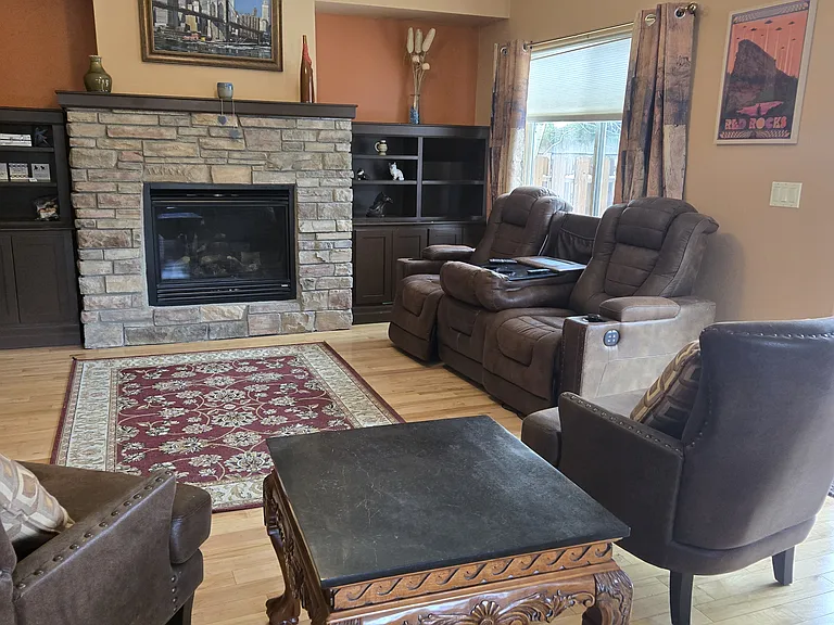 Living room with gas fireplace and leather furniture