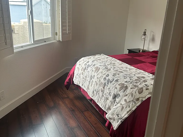 2nd Bedroom with Plantation Shutters. Artwork not on walls yet