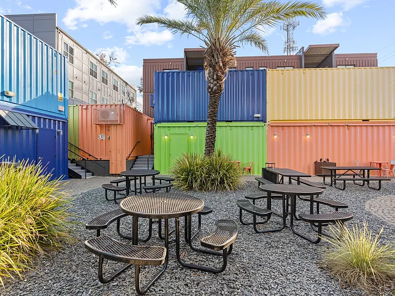 The courtyard is kept private by shipping containers stacked 20' high.