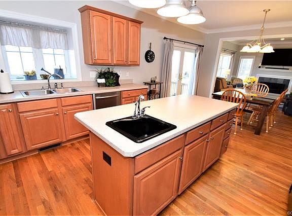 The kitchen is open to the eat in area and the family room, all hard wood flooring.  Window look out over the deck and open land.