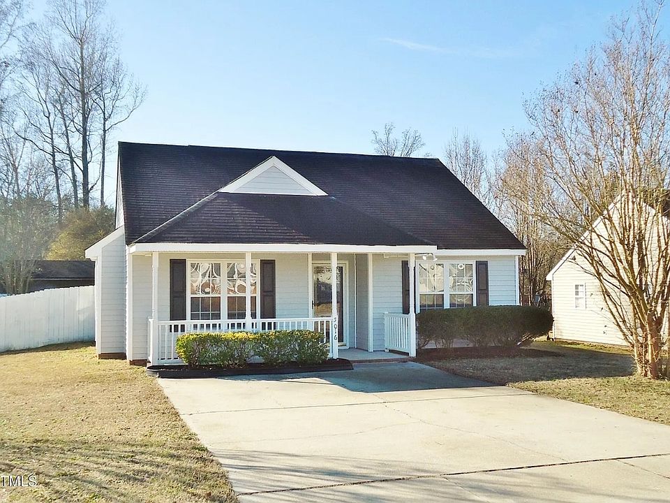 Private, off-street parking with a welcoming front porch, ready for a chair and table to sit with your morning coffee!