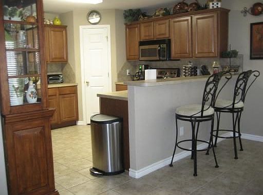 The kitchen features a breakfast bar and stainless steel appliances.