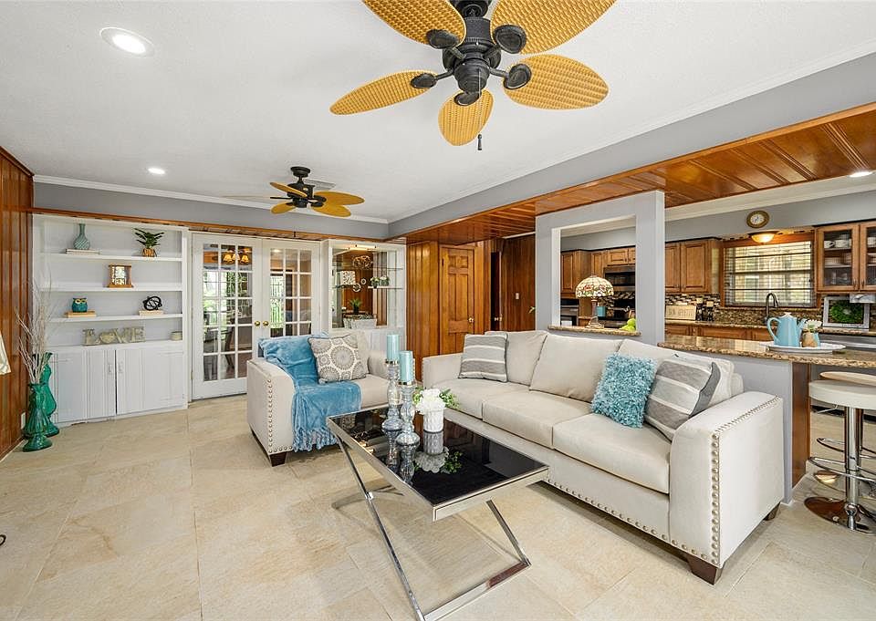 Amazing open concept between family room, kitchen and breakfast nock. Seller has recently installed the new tile floors. there are beautiful built-in cabinets and shelves. The rich wood panneling gives a dramatic accent to this area. There are 2 pair