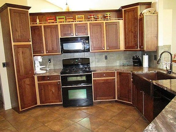 Kitchen showing dual energy range and copper sink