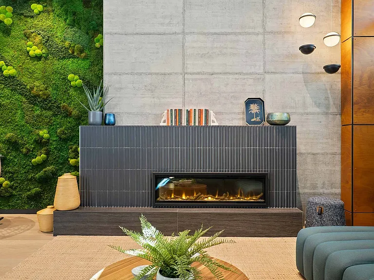 Create a cozy atmosphere with a modern fireplace, complemented by a lush green wall for a touch of nature.