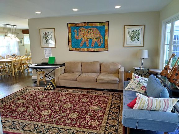 The main living area is spacious and has tall windows (on the right) overlooking the back yard.