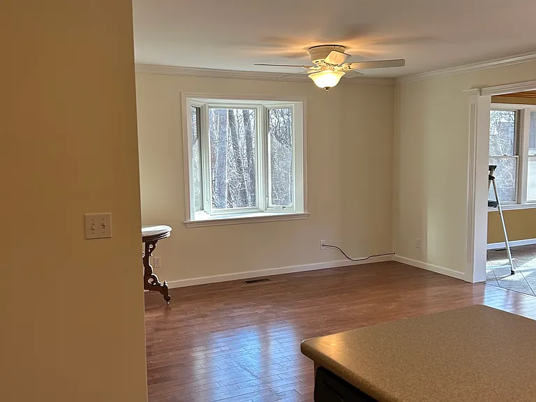 Additional living space with wood flooring.
