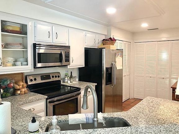 Kitchen complete with granite counter tops and laundry closet
