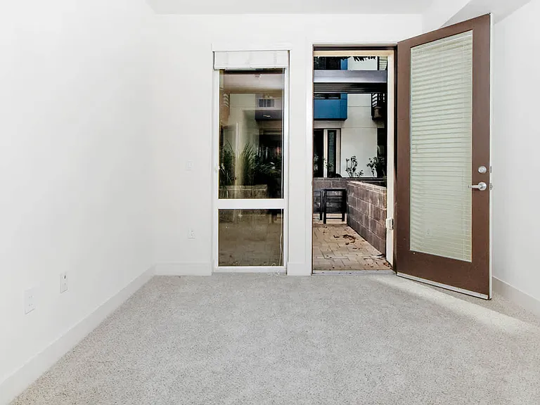 Carpeted Bedroom with Patio