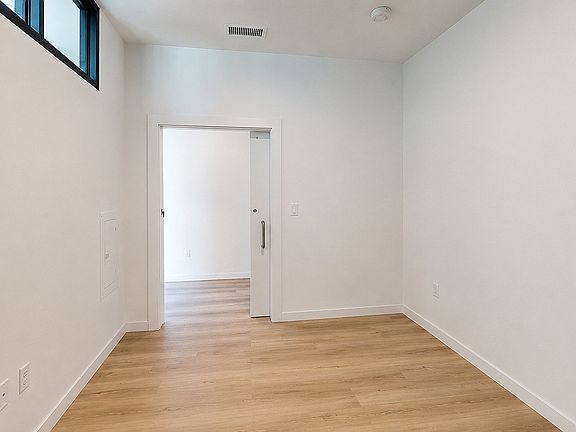 Comfortable bedroom with modern design and abundant natural light.