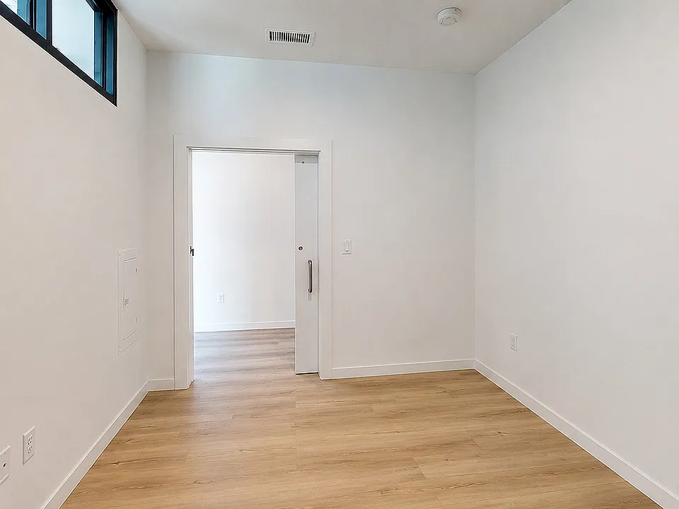 Comfortable bedroom with modern design and abundant natural light.