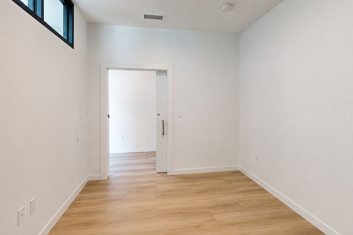 Comfortable bedroom with modern design and abundant natural light.