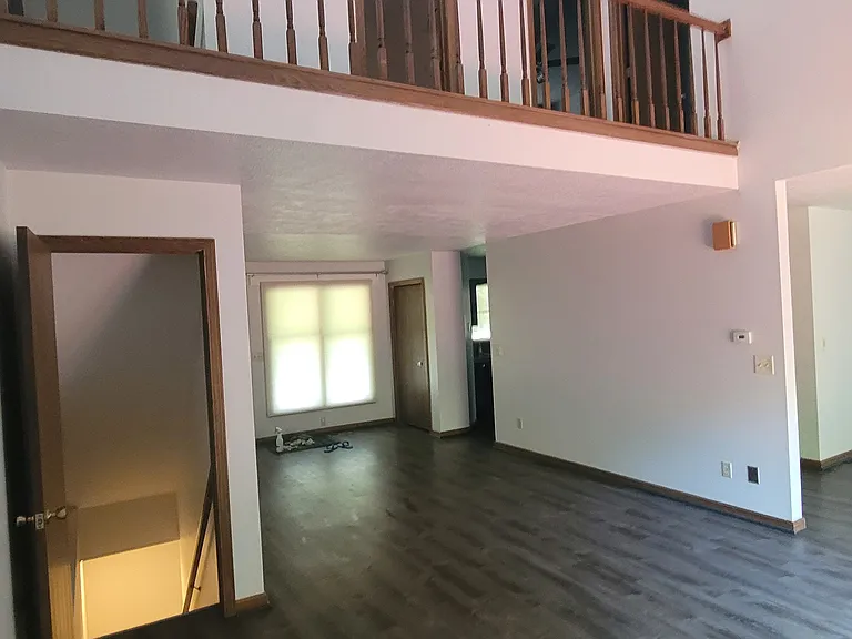 View from the living room showing the main entrance, dining room, walk-out basement entrance.