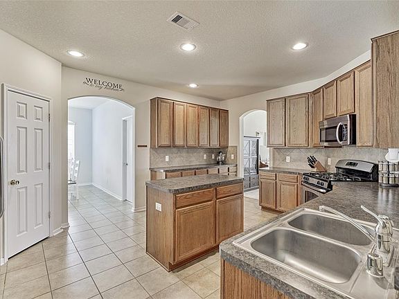 The large kitchen is open concept and has direct access to the large breakfast area and there is also direct access to the formal dining area! The main living area and first floor of the home has great flow and is perfect for entertaining! Lots of sp