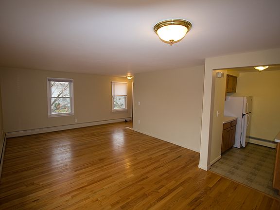 Living area view of entrance, street view windows and kitchen