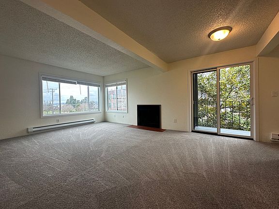 Spacious living room with brand new windows and slider doors.