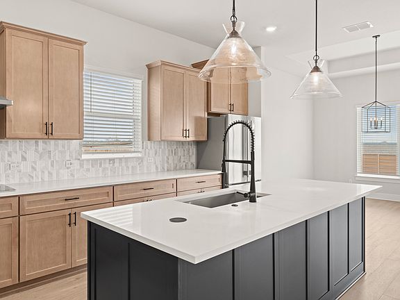 The kitchen has beautiful cabinetry.