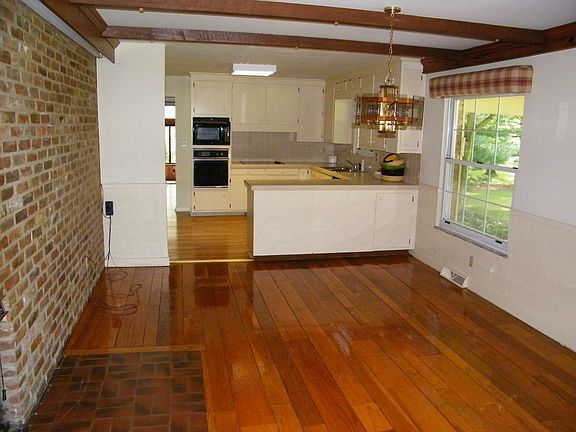 Kitchen and Eating Space. Hardwood floors and double sided fireplace. Cozy.