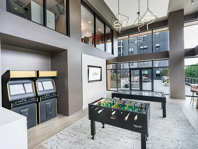 Visit our game room featuring foosball, arcade machines, and sleek seating_perfect for unwinding or friendly competition.