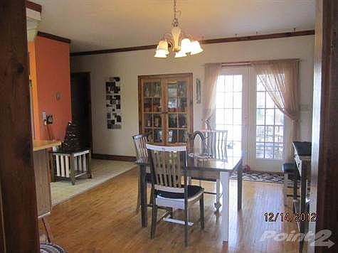 View of Dining Room and French doors to deck from Entry. Built in China Cabinet.