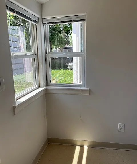Other side of the mud room with windows facing the yard with the flagstone patio