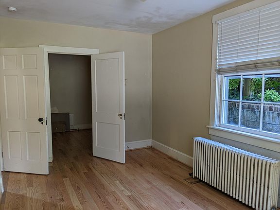 Front, north facing bedroom, with one door to the living room, other door to the hallway.
