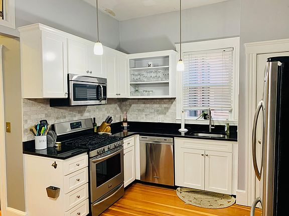 Fully updated kitchen complete with dishwasher, gas range stove, microwave, disposal, open concept shelving, and separate pantry!