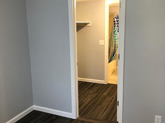 Master bedroom showing view of large walk through closet and private master bathroom.