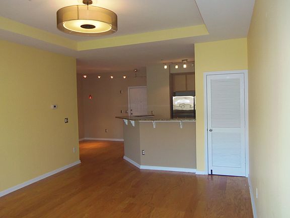 The living room features a view to the kitchen and dining rooms.