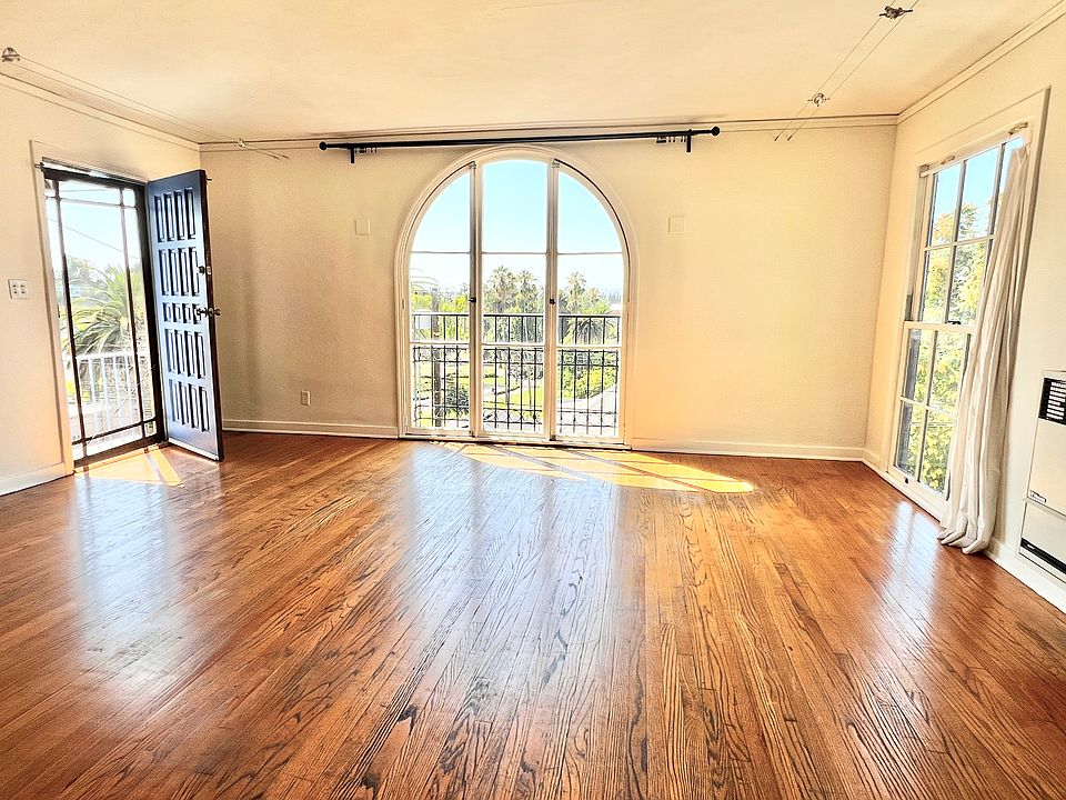 Light filled living room with domed ceiling and floor to ceiling windows with views of Echo Park Lake and mountains