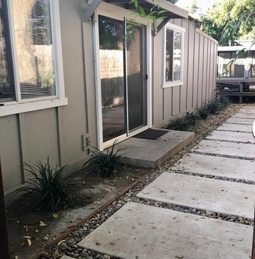 Come through the gate, and you_ll see the front door to the cottage (sliding door). Past the cottage you_ll find the garden shed.