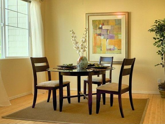 A dining room for all occasion that is illuminated with light from 9 foot ceilings and oversized win