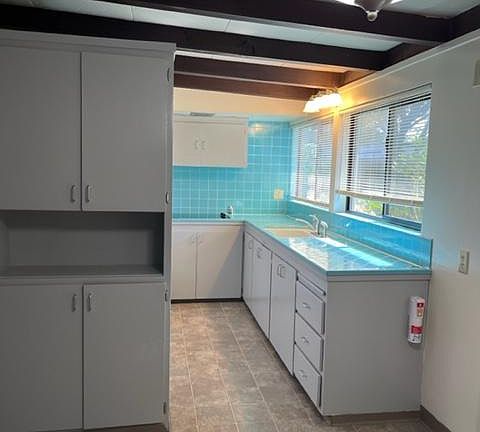 Kitchen with new window coverings.