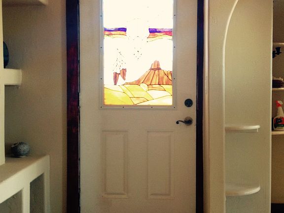Stained glass door in master bedroom that opens to an outsid