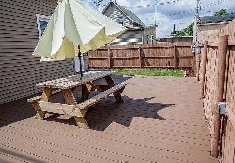 Oversized Deck off kitchen and mud room with deck lighting.