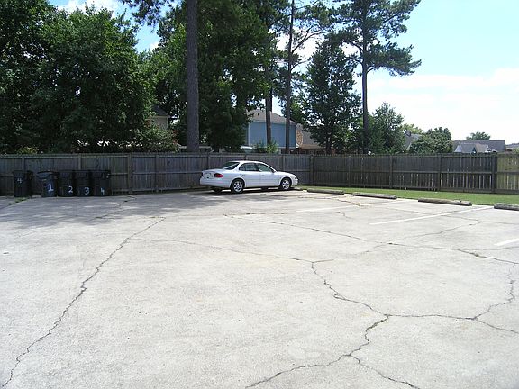 Rear Parking Area with Yard and Privacy Fence