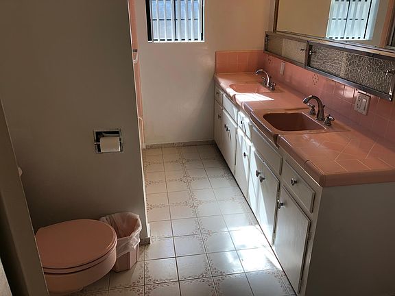 Double sink bathroom with a bath tub and shower head