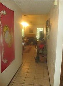Entrance hallway. Two beds and 1 bath are to the right. Li
