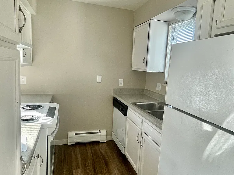 Experience culinary elegance with this modern kitchen setup, featuring sleek white cabinetry and matching white appliancesappliances. Experience culinary elegance with this modern kitchen setup, featuring sleek white cabinetry and matching white appliance