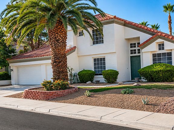Mediterranean-style exterior with low-maintenance desert landscaping
