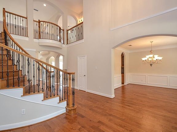 Spiral staircase with elegant wrought iron spindles.