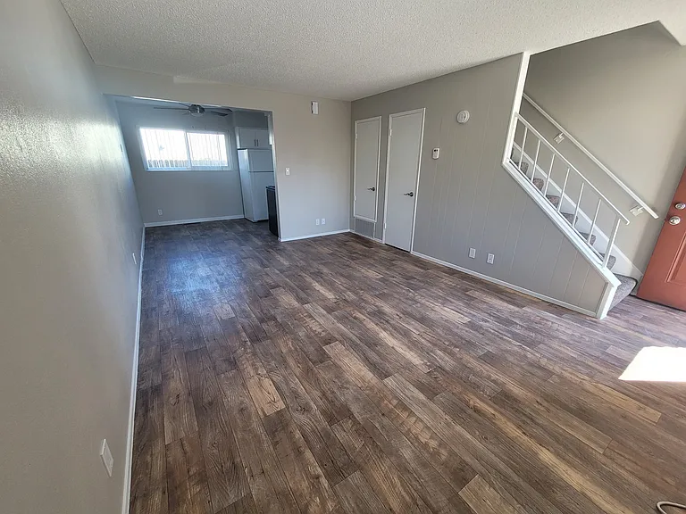 Spacious living and dining room with extra storage under the stairs.
