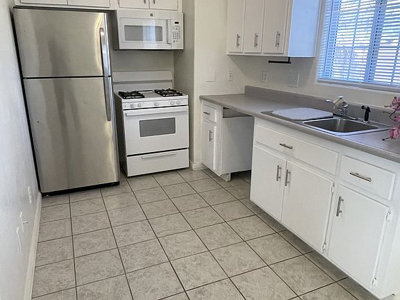 Kitchen, with appliances, dishwasher being installed this week
