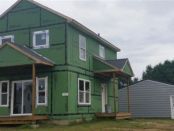 Sliders from living room lead to the open side porch (which will have a railing)