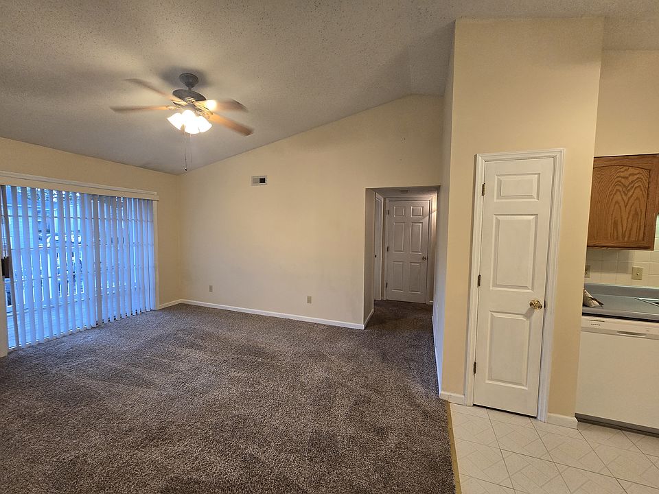 Spacious family room with vaulted ceilings and access to private balcony