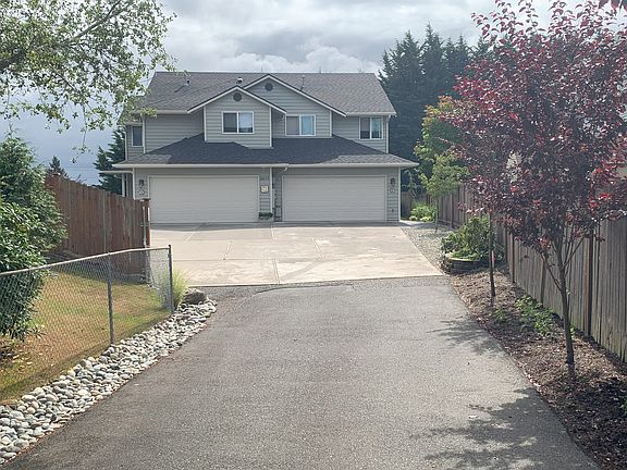 Driveway to front of home. Unit A is the left-side garage, Unit B is on the right, and Unit C stairway is furthest to the left. It is located behind and under Unit A.